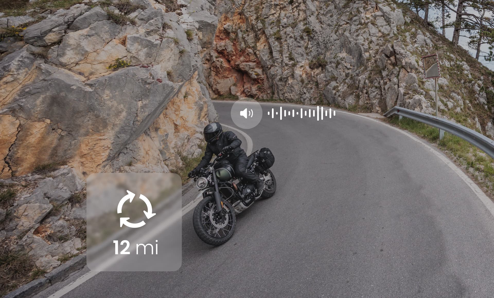 Motorcyclist taking a sharp turn with navigation and audio prompts from the app.